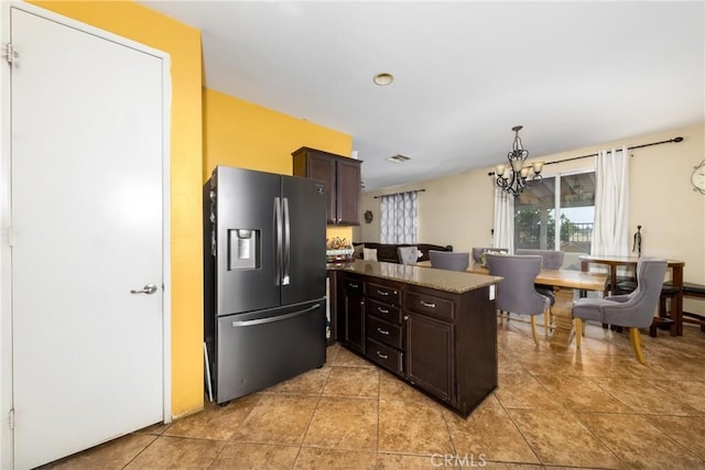 kitchen featuring pendant lighting, stainless steel refrigerator with ice dispenser, light tile patterned floors, dark brown cabinets, and a chandelier