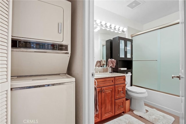 1440 Brett Pl Unit 62, San Pedro, CA 90732 - full bathroom featuring estacked washer and dryer, vanity, and enclosed tub / shower combo