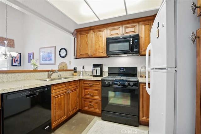 kitchen with black appliances, light stone counters, brown cabinetry, and a sink