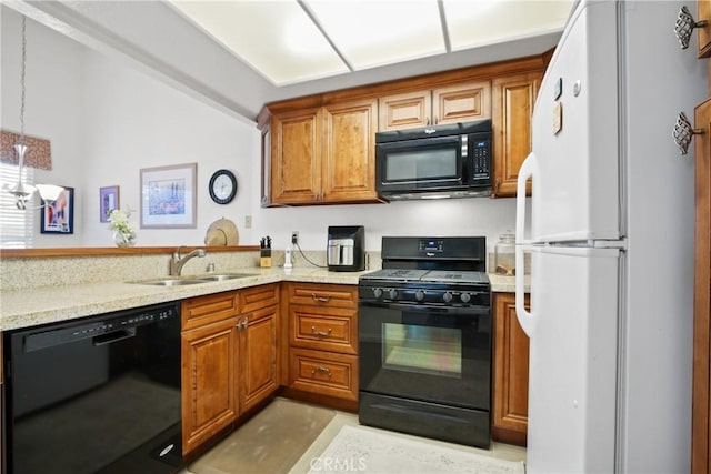 kitchen featuring brown cabinetry, a sink, black appliances, and light stone countertops