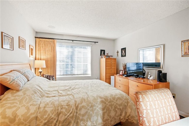 bedroom featuring a textured ceiling and multiple windows