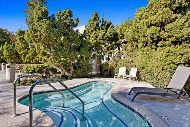 view of pool featuring a patio and fence