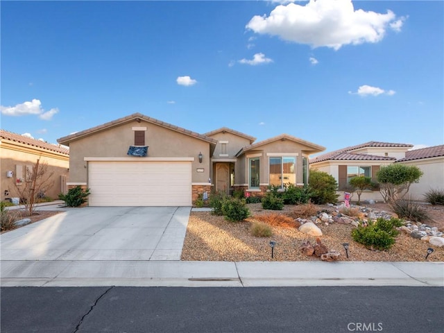 view of front of property featuring a tile roof, stucco siding, an attached garage, stone siding, and driveway