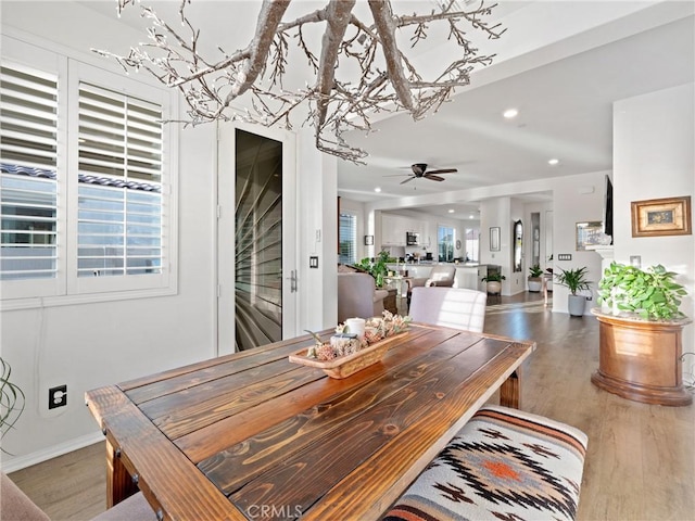 dining area featuring a ceiling fan, recessed lighting, baseboards, and wood finished floors