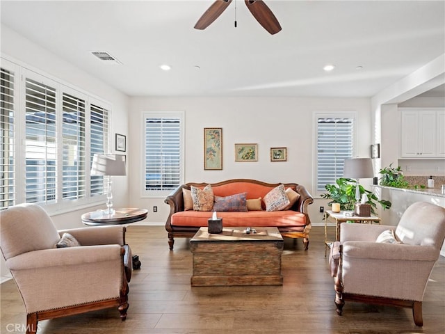 living area featuring ceiling fan, wood finished floors, visible vents, and recessed lighting