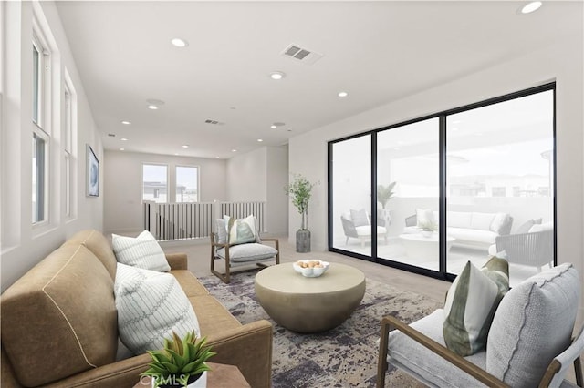 living room featuring visible vents and recessed lighting