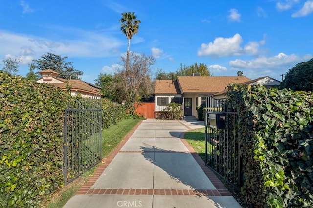 exterior space featuring a fenced front yard and a gate