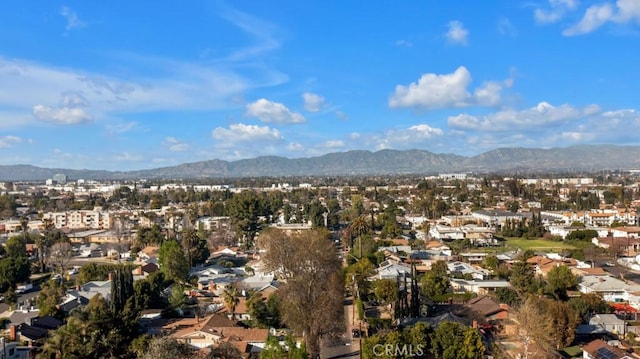 drone / aerial view featuring a residential view and a mountain view