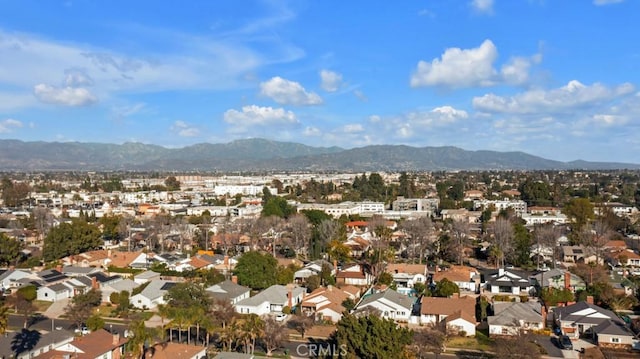 drone / aerial view featuring a residential view and a mountain view