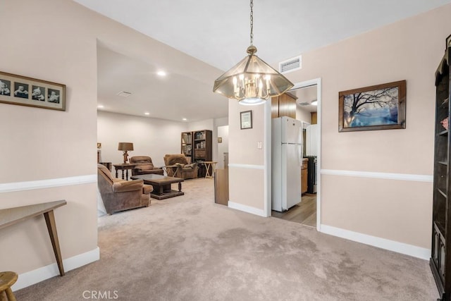 interior space featuring light carpet, recessed lighting, visible vents, and baseboards