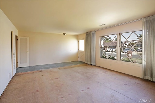 unfurnished room with concrete floors