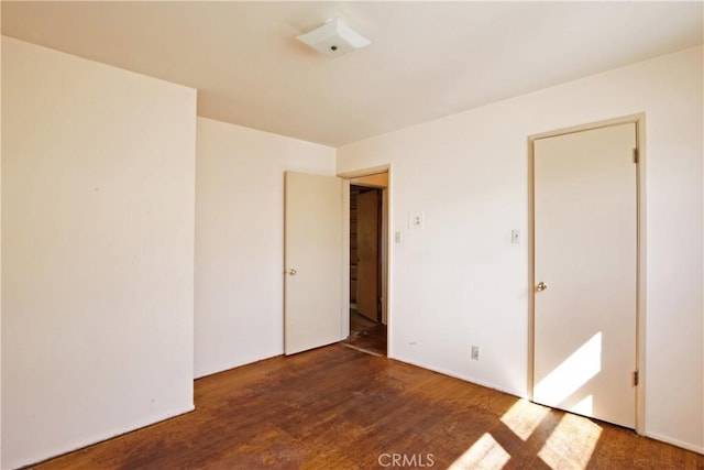 empty room featuring dark wood finished floors