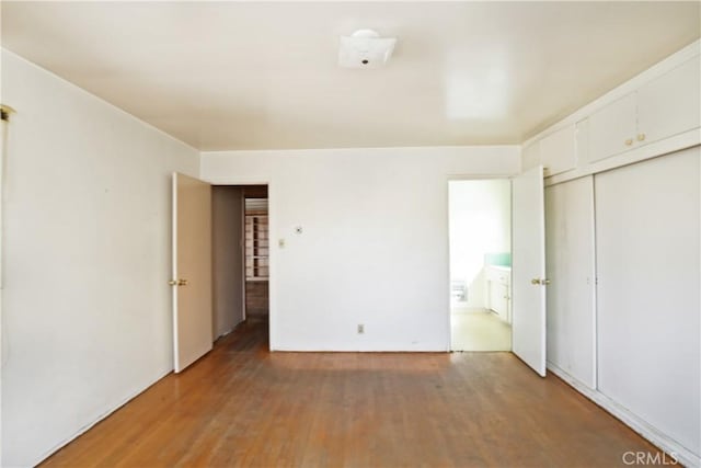 unfurnished bedroom with wood finished floors