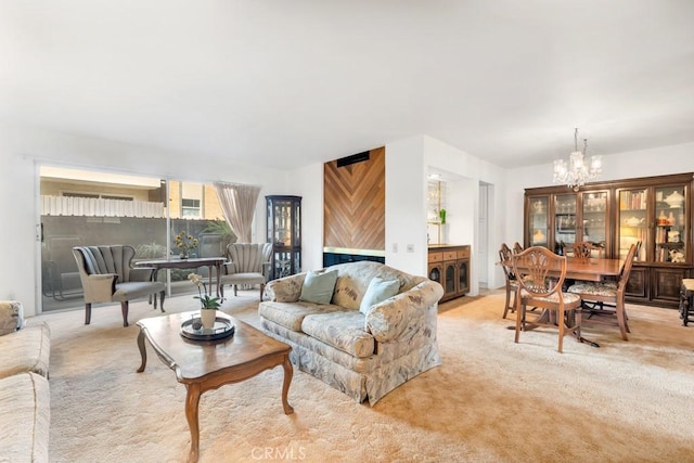 living area with a chandelier and light carpet