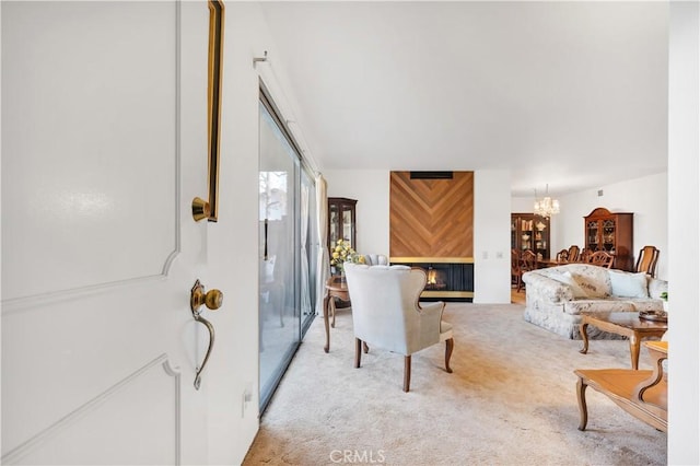 interior space with light colored carpet, a multi sided fireplace, and an inviting chandelier