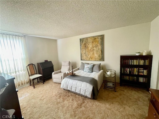bedroom with carpet and a textured ceiling