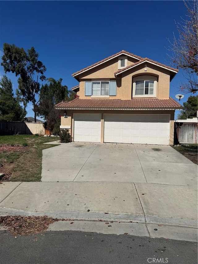 view of front facade featuring concrete driveway, an attached garage, a tiled roof, and stucco siding