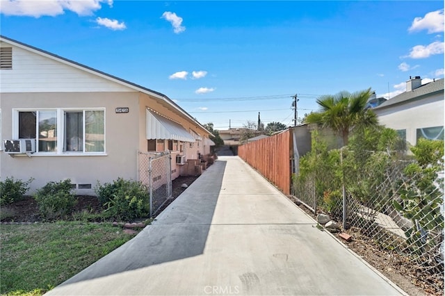 view of home's exterior featuring crawl space, fence, cooling unit, and stucco siding