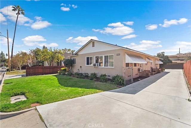 view of home's exterior featuring crawl space, stucco siding, fence, and a yard