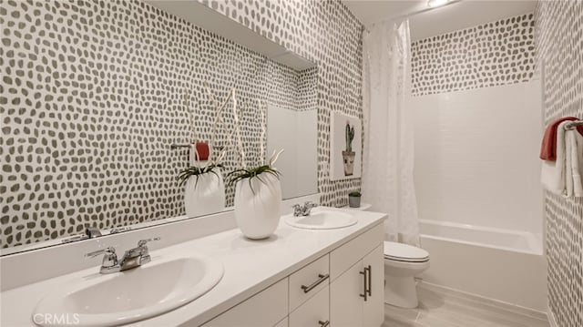 bathroom featuring toilet, shower / bathtub combination with curtain, double vanity, and a sink