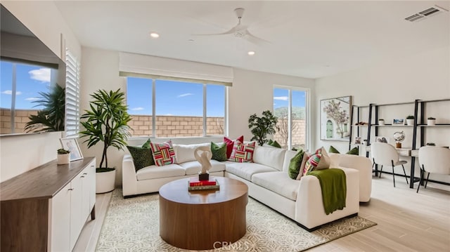 living area with light wood-style floors, recessed lighting, visible vents, and ceiling fan