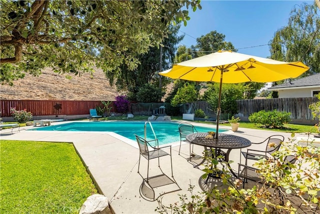 view of swimming pool with a fenced backyard, a patio, and a yard