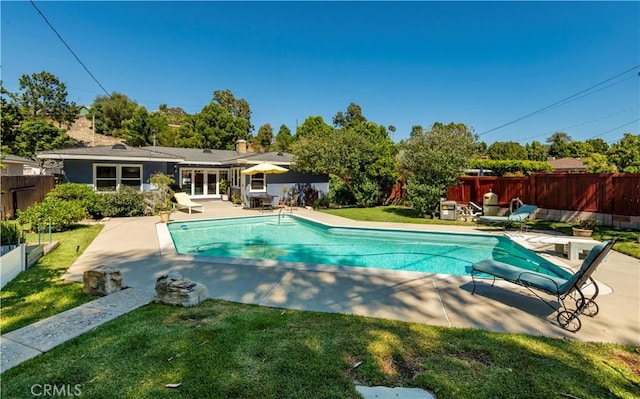 view of pool featuring a patio, french doors, fence, and a fenced in pool