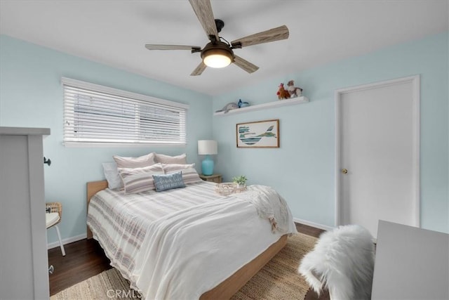 bedroom featuring ceiling fan, baseboards, and wood finished floors