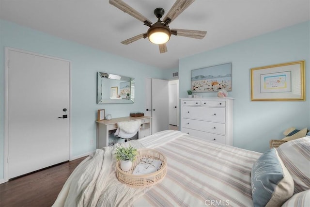 bedroom with a ceiling fan, visible vents, and wood finished floors