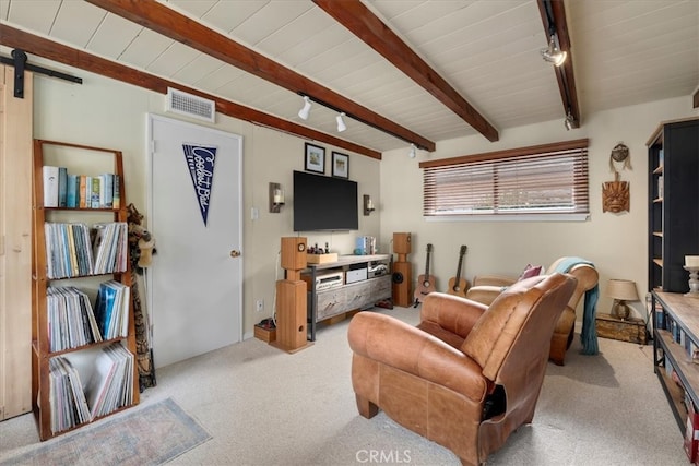 living room featuring carpet floors, rail lighting, visible vents, a barn door, and beamed ceiling