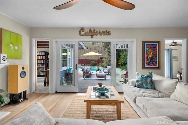 living area featuring a ceiling fan and wood finished floors