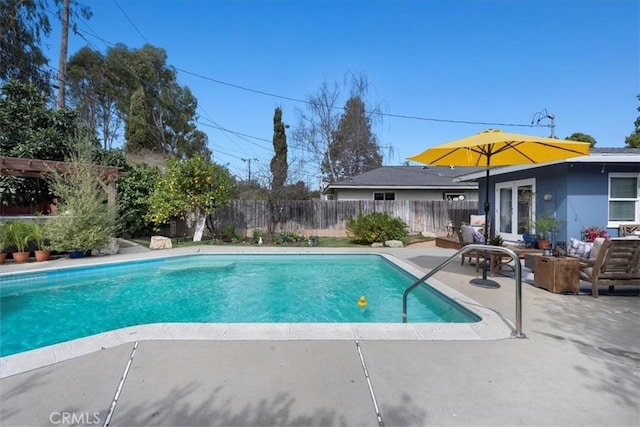 view of swimming pool featuring a patio area, a fenced backyard, and a fenced in pool