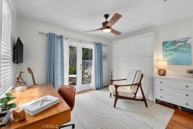 office space featuring ceiling fan, french doors, and light wood-type flooring