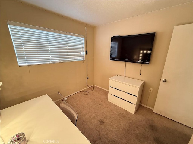 bedroom featuring light colored carpet and baseboards