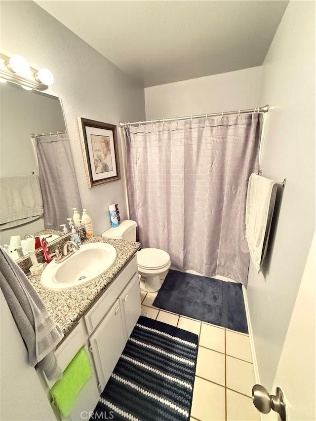 bathroom featuring toilet, vanity, and tile patterned floors