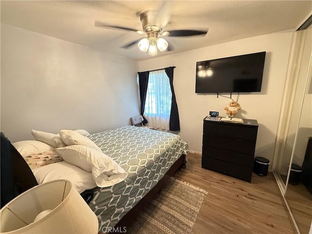 bedroom with a ceiling fan and wood finished floors