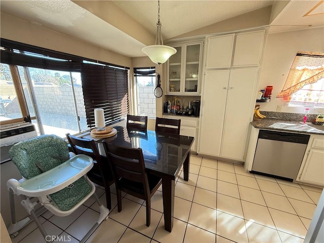 dining area featuring lofted ceiling, light tile patterned flooring, and cooling unit