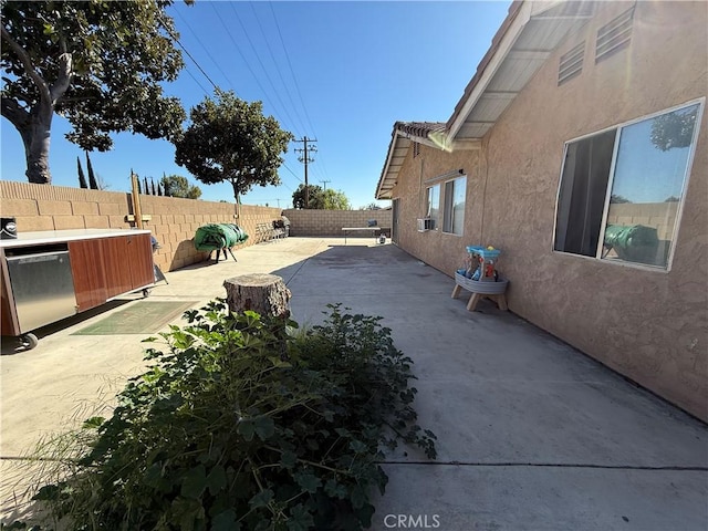 exterior space with a fenced backyard and a patio