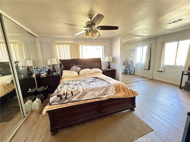 bedroom with visible vents, a ceiling fan, light wood-style flooring, a textured ceiling, and a closet