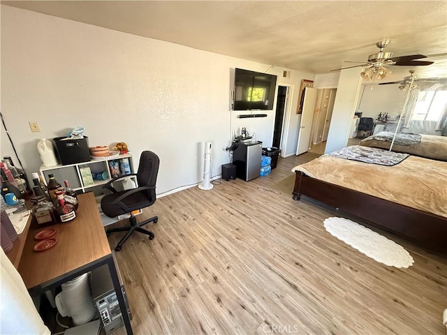 bedroom with light wood finished floors and ceiling fan