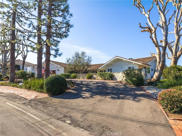 ranch-style home featuring driveway and a residential view