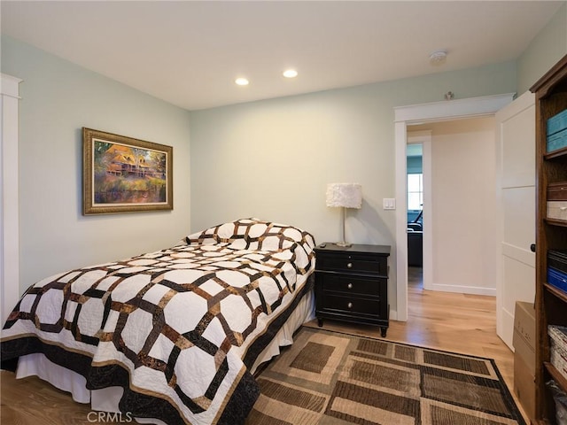 bedroom with light wood-style flooring and recessed lighting