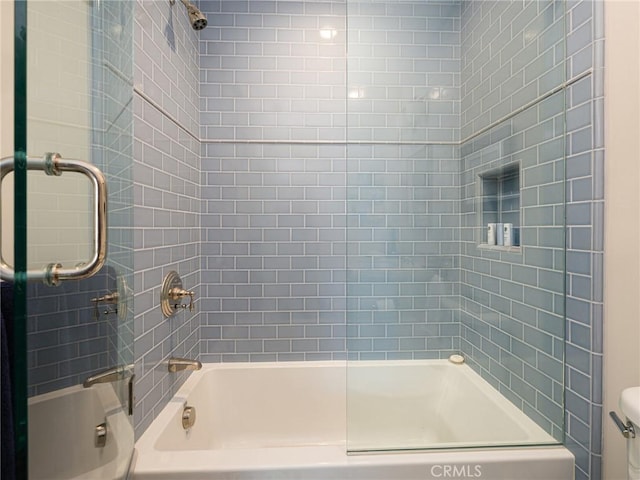 bathroom featuring toilet and bathing tub / shower combination