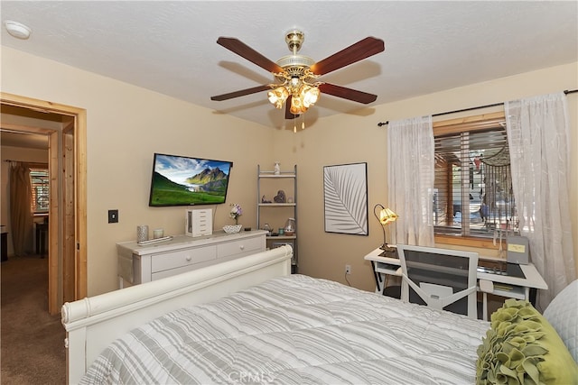 bedroom featuring a textured ceiling, carpet, and a ceiling fan