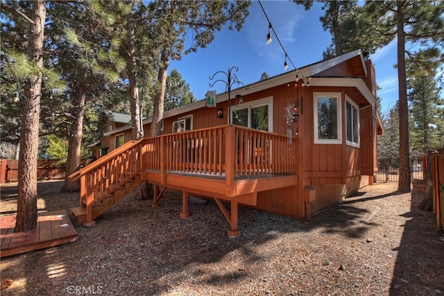 back of property featuring fence and a deck