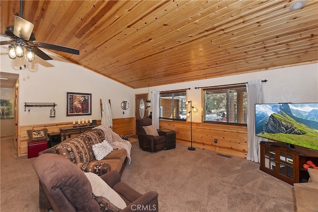 carpeted living room with a wainscoted wall, lofted ceiling, ceiling fan, wooden walls, and wooden ceiling