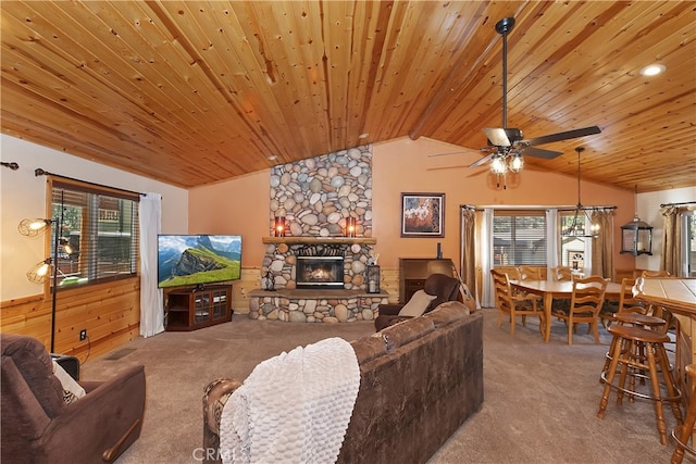 carpeted living room with wooden ceiling, ceiling fan, vaulted ceiling, and a stone fireplace