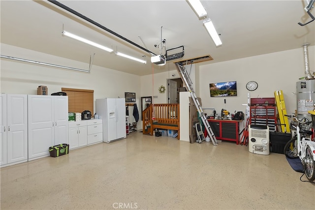 garage featuring white fridge with ice dispenser, a workshop area, and a garage door opener