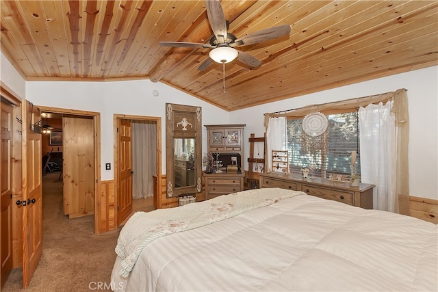 bedroom with lofted ceiling, a wainscoted wall, wooden ceiling, and light carpet