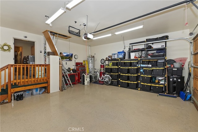 garage with water heater and a garage door opener